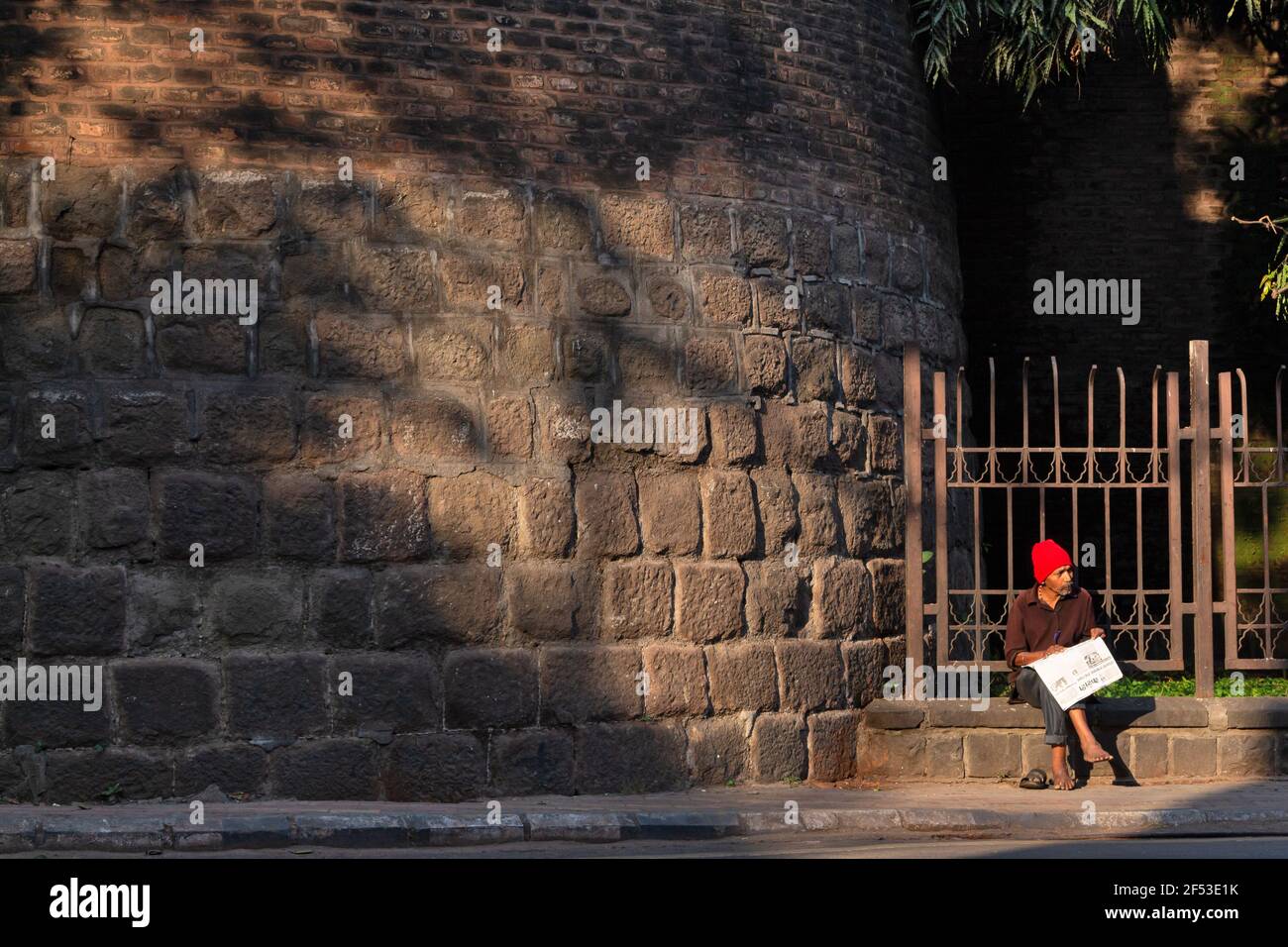 Uomo che legge giornale, Pune, Maharashtra, India. Foto Stock