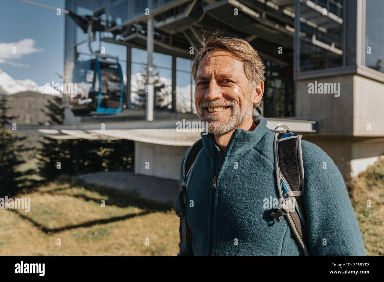 Uomo maturo sorridente in piedi alla stazione della funivia di Maria Alm, Salzburger Land, Austria Foto Stock