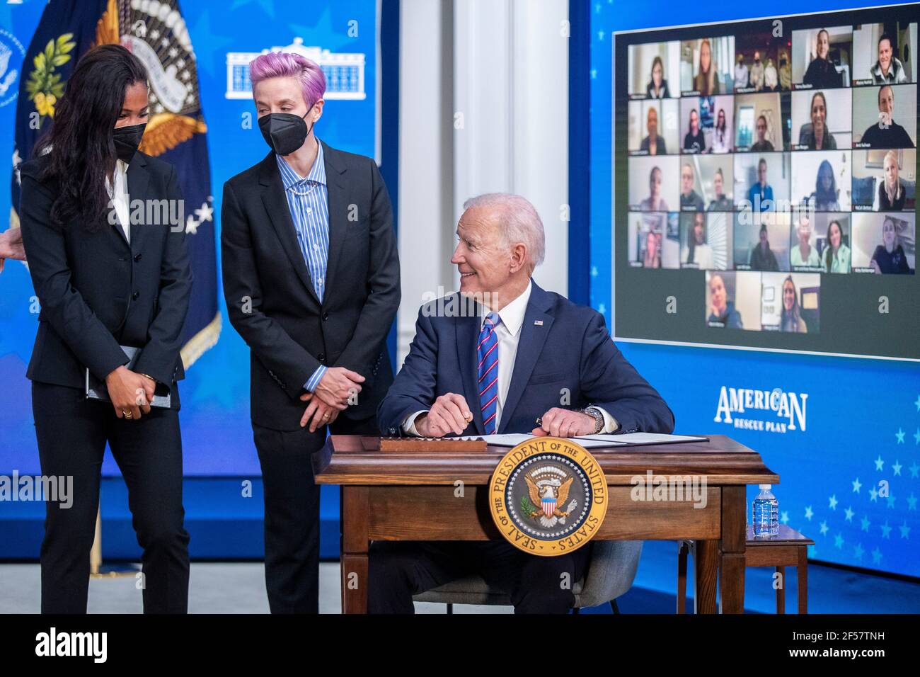 Washington, Stati Uniti. 24 Marzo 2021. Il presidente DEGLI STATI UNITI Joe Biden, con Margaret Purce (L), Megan Rapinoe (C) e altri membri della squadra WomenÕs nazionale di calcio degli Stati Uniti, firma un annuncio durante un evento per celebrare la Giornata di paga uguale nella sala da pranzo di Stato della Casa Bianca a Washington, DC, USA, 24 marzo 2021. EQUAL Pay Day segna il tempo extra che una donna media negli Stati Uniti impiega per guadagnare la stessa retribuzione che i loro colleghi maschi hanno fatto l'anno civile precedente. Credit: Sipa USA/Alamy Live News Foto Stock