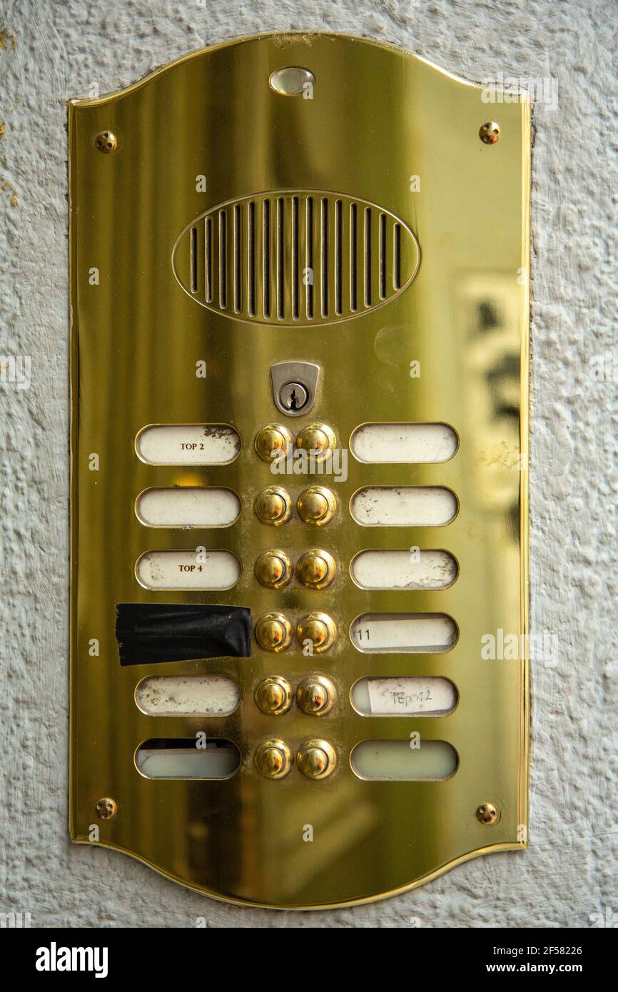 Pulsanti Intercom in ottone con tag nome per un blocco appartamento Foto Stock