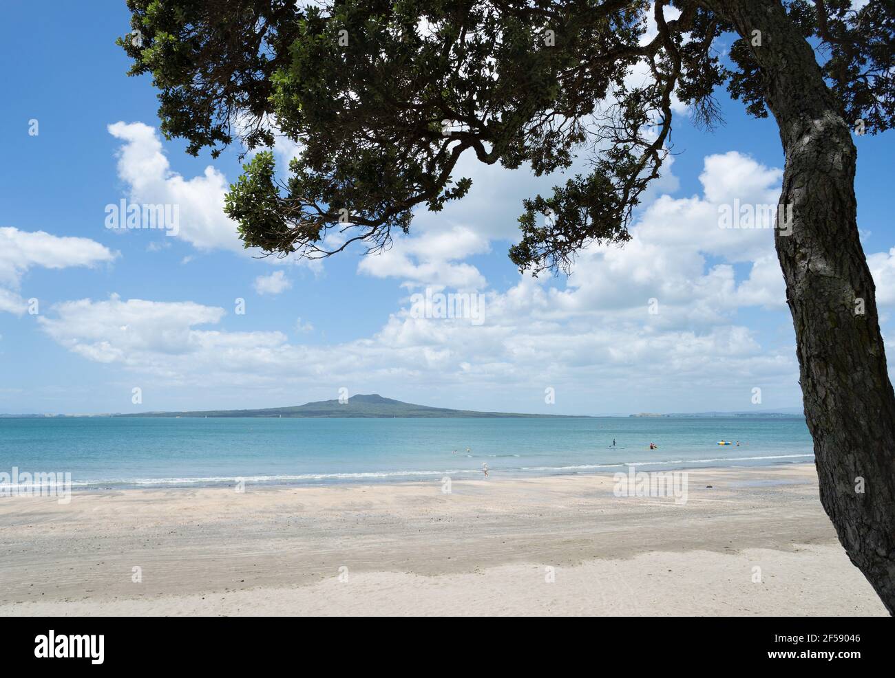 Estate alla spiaggia di Takapuna con vista sull'Isola di Rangitoto e sulle persone che giocano sulla spiaggia, North Shore, Auckland Foto Stock