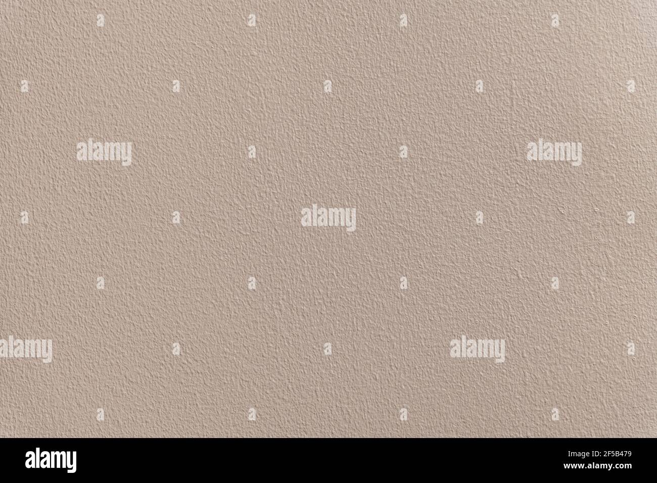 Parete della casa con struttura dipinta in beige. Foto Stock