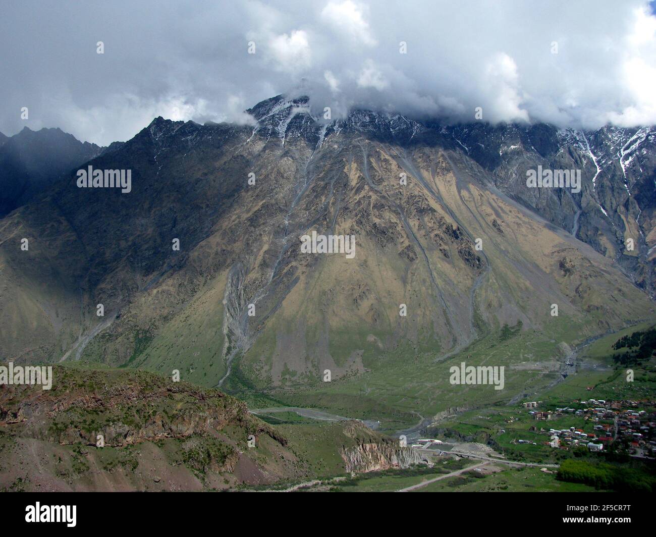 Vista dalla chiesa della Trinità di Gergetier alle montagne caucasiche Foto Stock