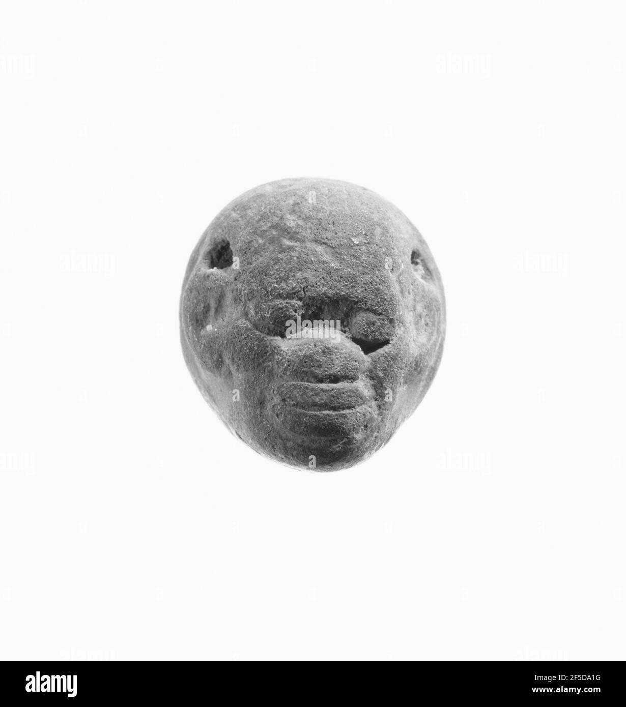 Sigillo in forma di testa nera africana, inciso con un combattimento animale. Sconosciuto Foto Stock