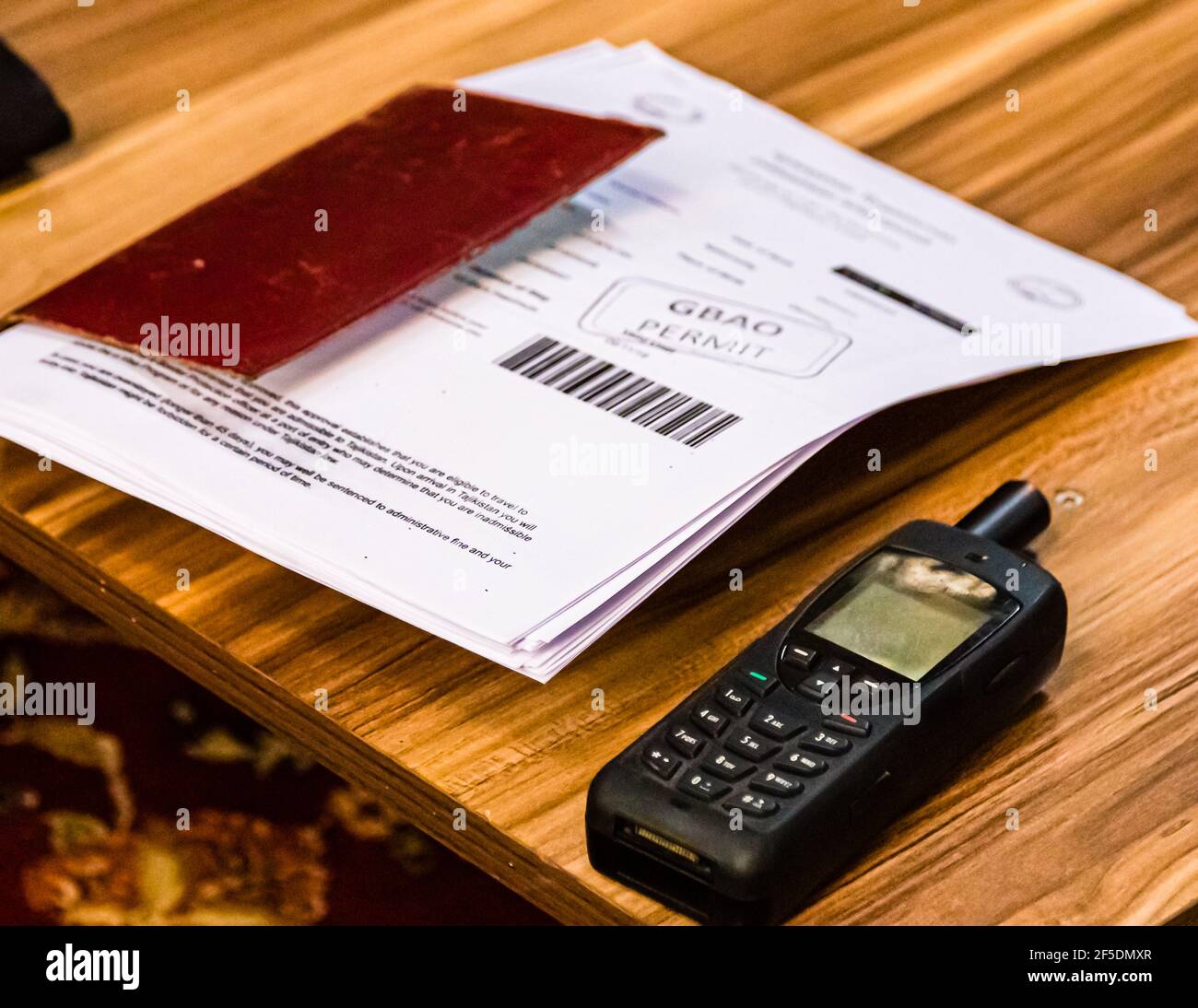 Accanto al telefono satellitare, sempre a portata di mano: Un mucchio di copie di passaporti e visti. Khorugh, Tagikistan Foto Stock