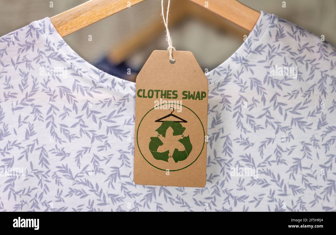 Abbigliamento Scambia e ricicla l'icona sull'etichetta della t-shirt, la moda sostenibile e zero rifiuti, riciclare vestiti e tessuti per ridurre gli sprechi Foto Stock