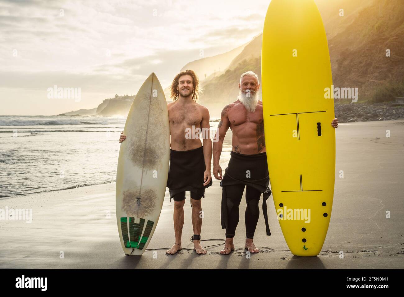 Amici felici con diverse età surf insieme - persone sportive Divertirsi durante la giornata di surf in vacanza - stile di vita sportivo estremo concetto Foto Stock