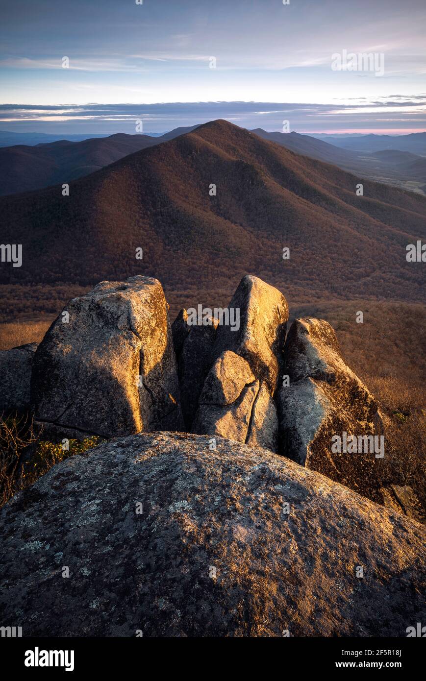 Luce mattutina che illumina i massi sulla cima della Sharp Top Mountain tra le vette della Otter of the Blue Ridge Mountains. Foto Stock