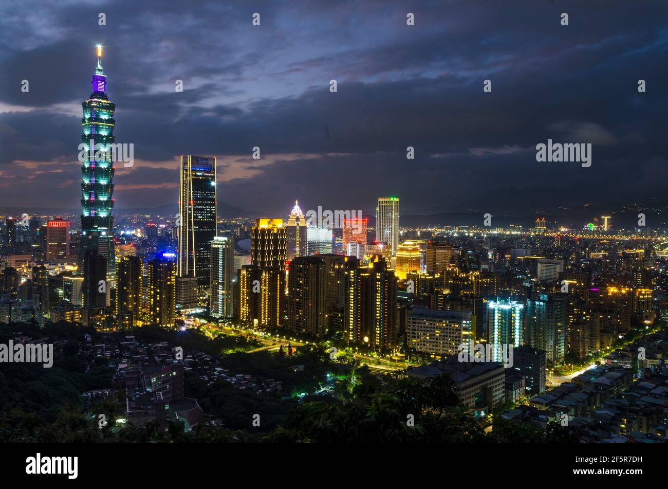 Notte giù città illuminata da luci colorate. Foto Stock
