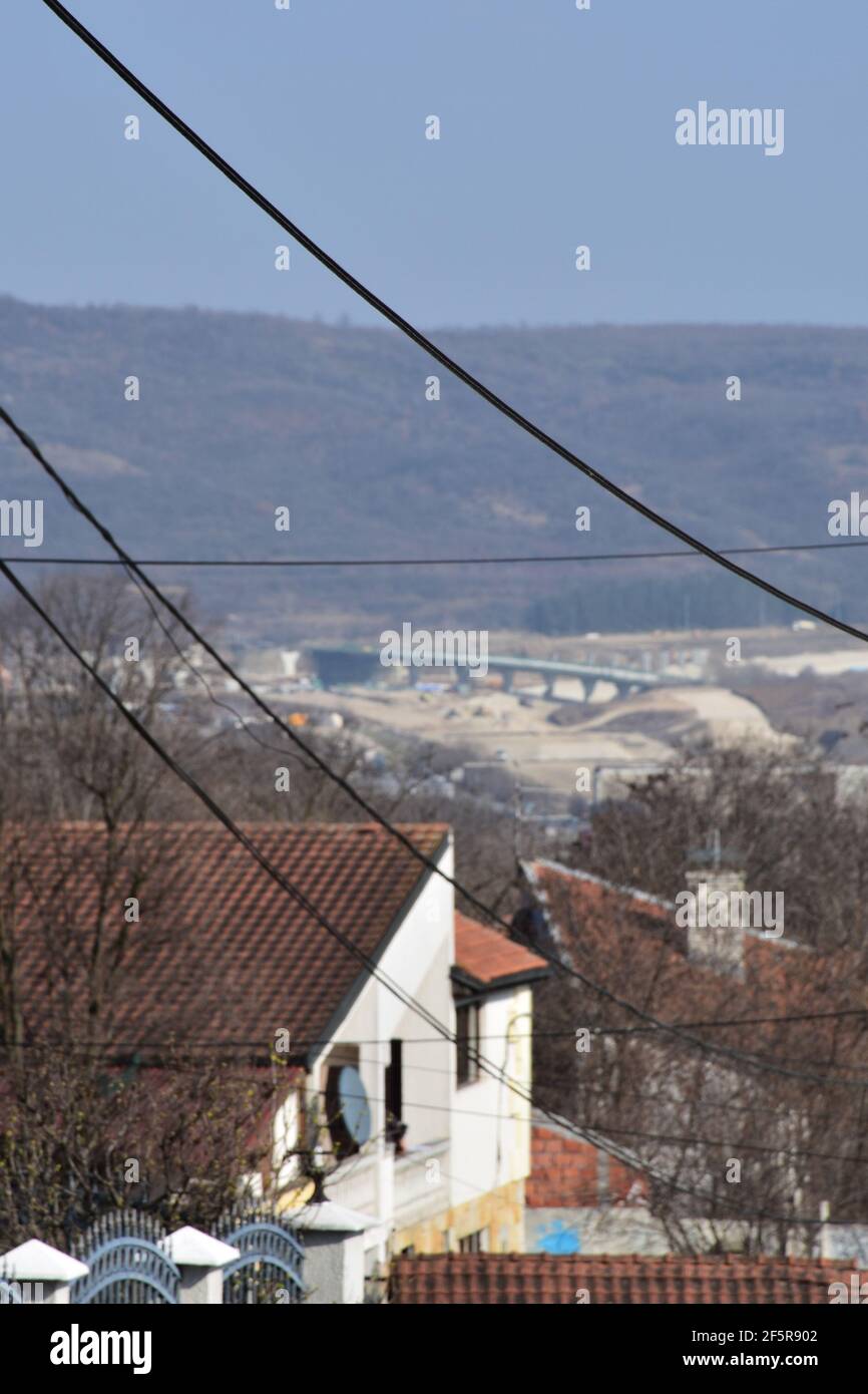 Case su una collina e una vista di lavori di costruzione in distanza Foto Stock