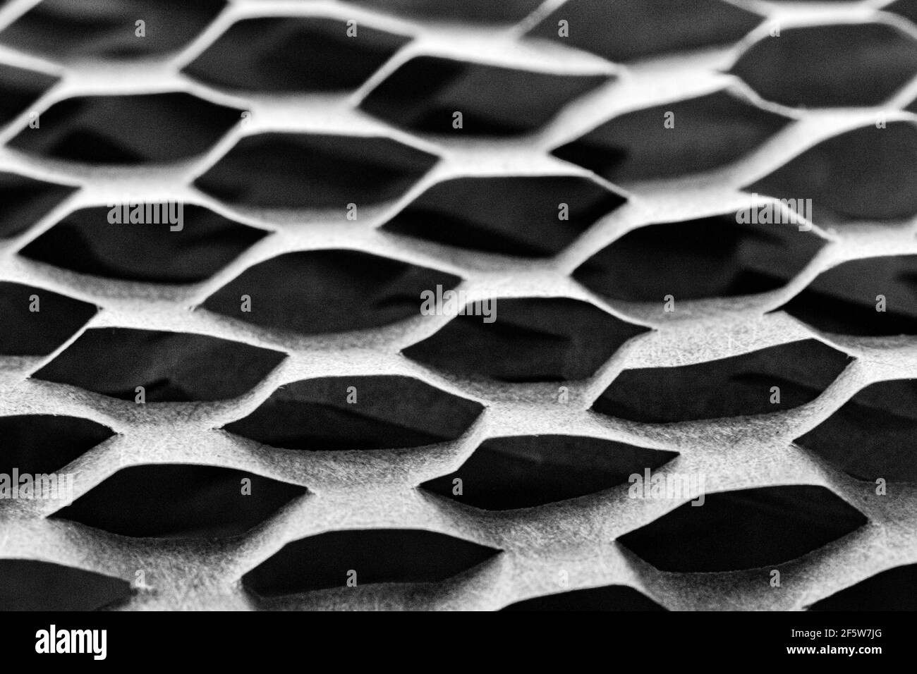 Una macro shot di un pezzo di carta marrone da imballaggio diventa un disegno geometrico. Foto Stock