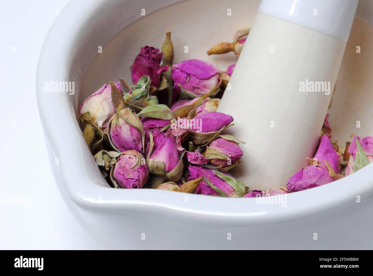 Boccioli di rosa essiccati sono schiacciati in mortaio, grattugiato, germoglio, germoglio Foto Stock