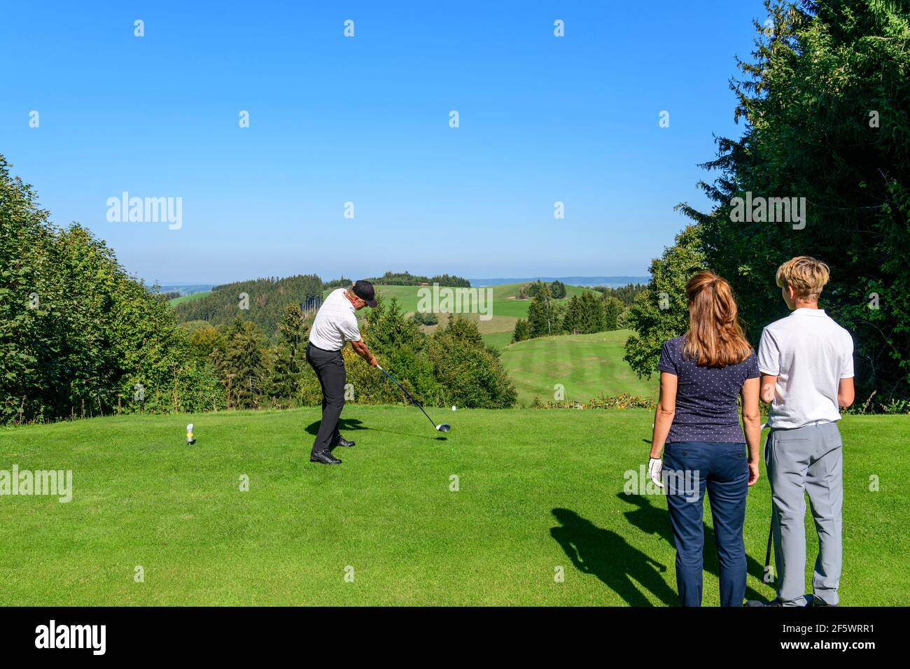 Un gruppo di golfisti su un campo da golf nel Allgäu, giocando a golf in un bellissimo paesaggio Foto Stock