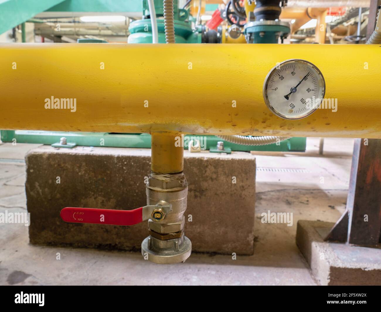 Termometro industriale sul tubo del sistema. Indicatori sul tubo giallo dei  fanghi nell'azienda delle acque reflue. Stazione di pompaggio sotterraneo  Foto stock - Alamy