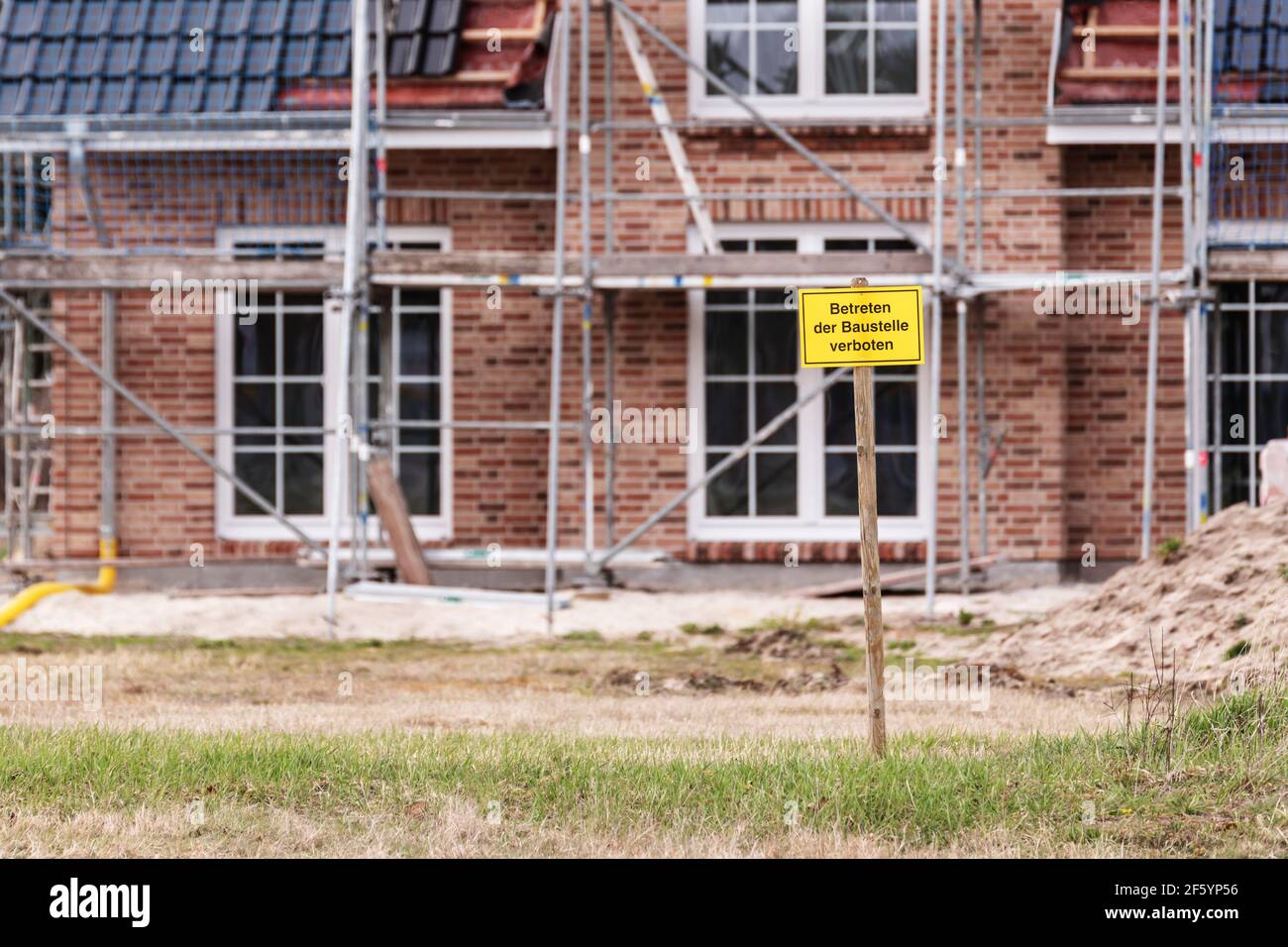 Di fronte ad una casa di famiglia quasi finita è un Segno con l'iscrizione tedesca cantiere Nessun trasgressione Foto Stock