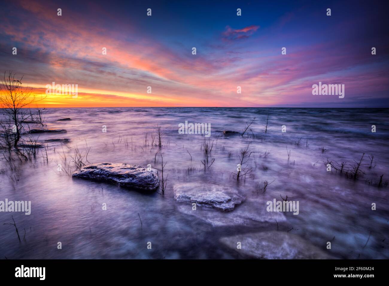 Una suggestiva alba primaverile sul Lago Michigan a Tofts Point vicino a Baileys Harbour nella Door County Wisconsin. Il Tofts Point è una riserva nazionale di zone umide. Foto Stock