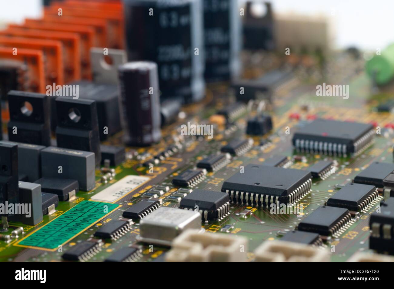 Primo piano di PCB con microchip, processore, circuiti integrati, resistenze e collegamenti elettronici. Foto Stock