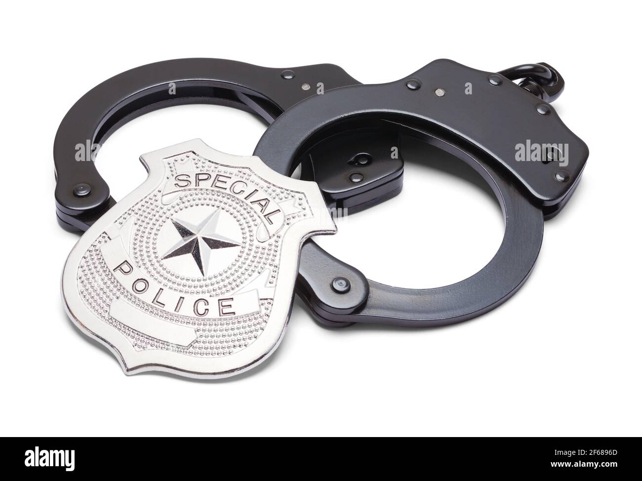 Manette in metallo nero e distintivo della polizia Foto stock - Alamy
