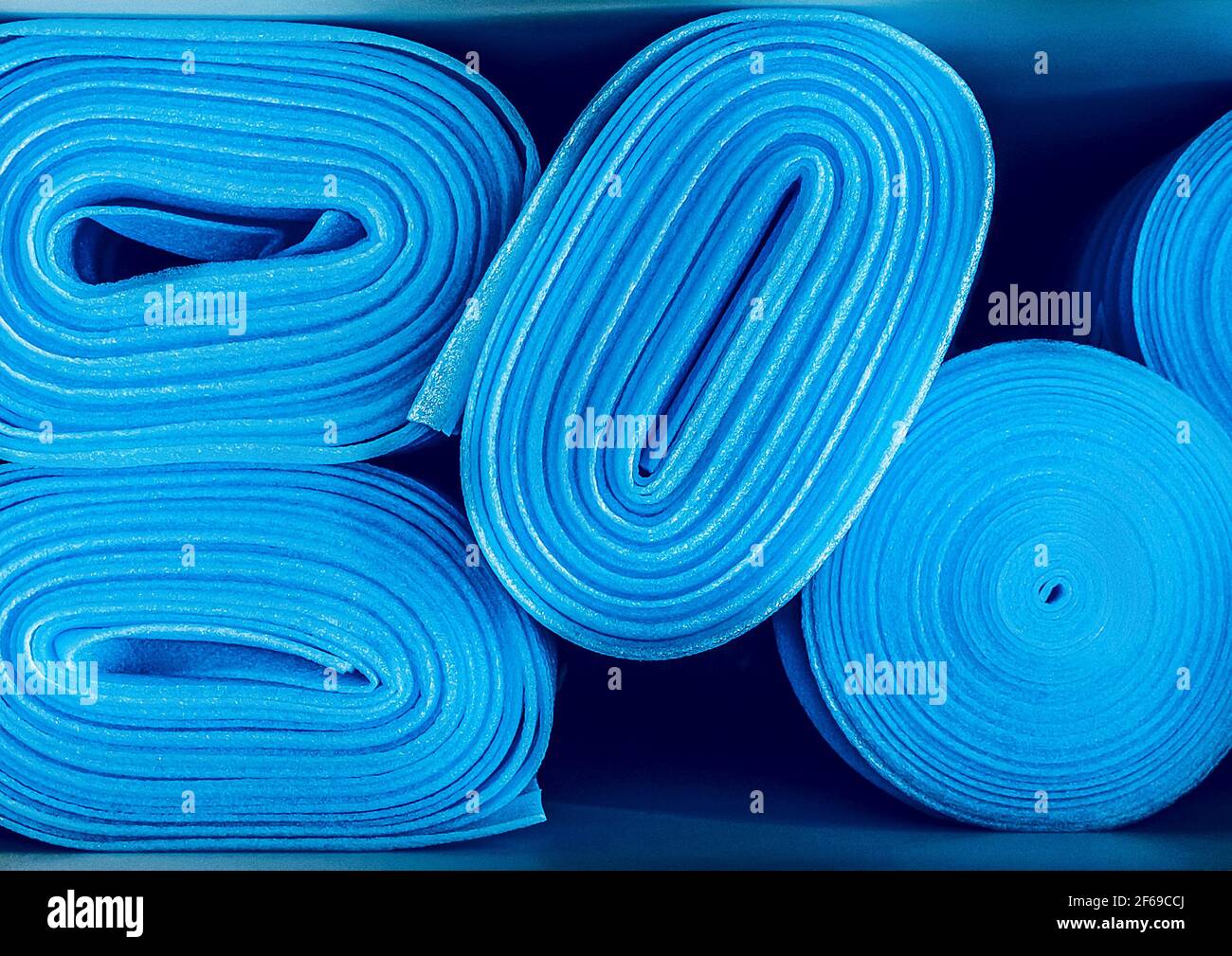 Pavimenti in laminato e parquet in rotoli blu da vicino. Materiale da costruzione resistente alla corrosione, ecologico e sicuro. Rotoli di schiuma o tappetino yoga Foto Stock