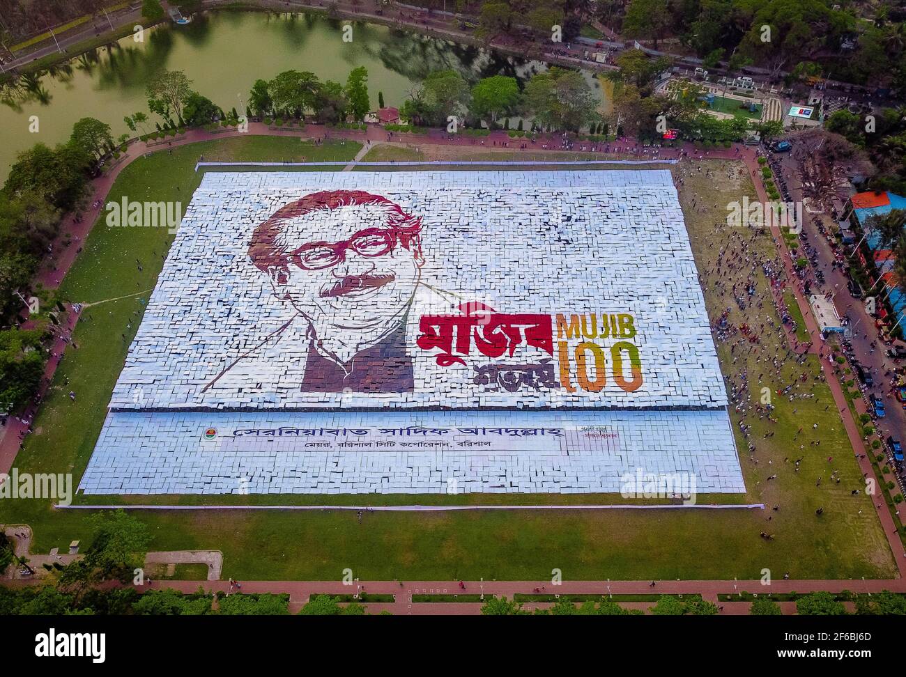 Le persone di Barisal, una città del Bangladesh, hanno realizzato il più grande logo umano in più di 60,000 metri quadrati di area campo per celebrare il 100 ° anno di nascita del Padre della nazione, "Bangabandhu, Sheikh Mujibur Rahman il 30 marzo 2021. Totale 10,050 cartelloni in totale 120 linee, ciascuna delle quali è composta da 84-85 cartelloni, sono utilizzati per realizzare il logo umano più lungo e più grande. Minimo 100-120 lavoratori hanno lavorato duramente fino a 12-13 giorni per fare questo logo gigante e circa 10000 persone si sono levate in piedi alla volta con i cartelli nelle loro mani per rendere il logo con successo per essere visibile. (Foto di Mustasinur Foto Stock