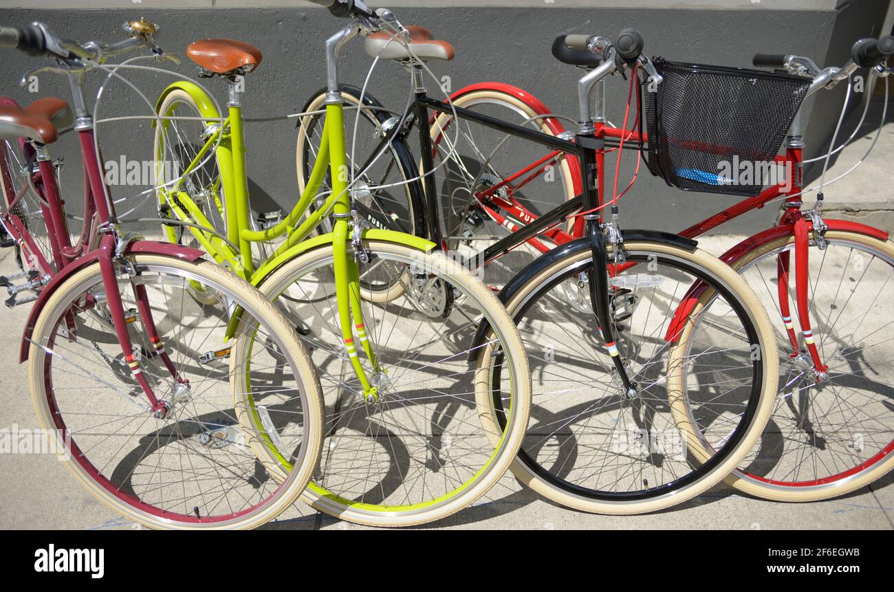 una fila di biciclette colorate all'esterno del negozio di un venditore Foto Stock