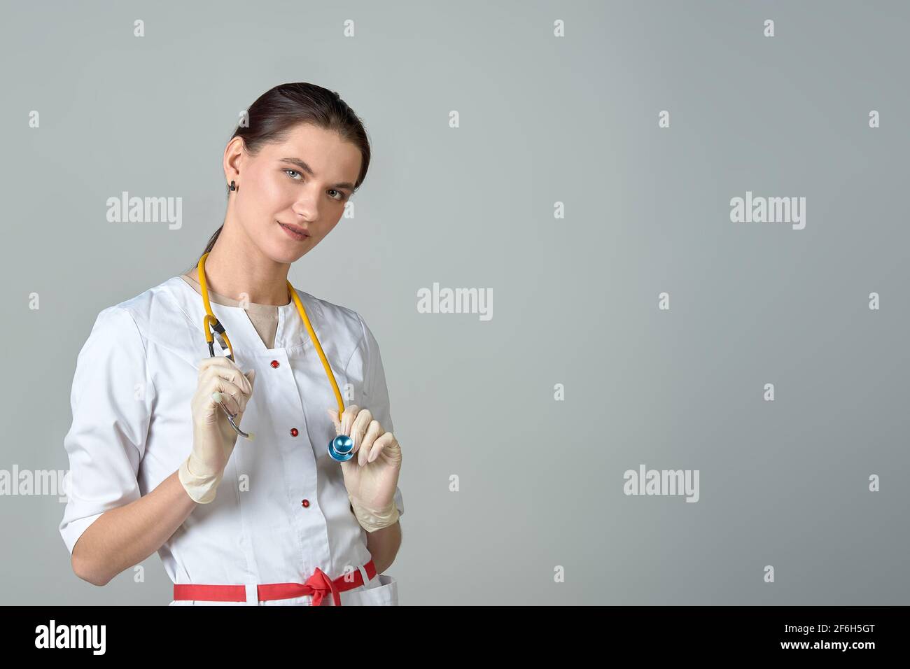 un giovane medico in un cappotto bianco con uno stetoscopio Foto Stock