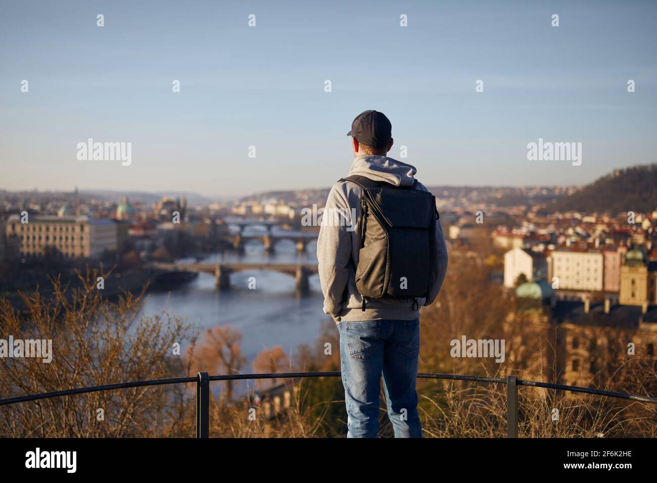 Uomo che guarda il paesaggio urbano all'alba. Skyline urbano con Ponte Carlo a Praga, Repubblica Ceca. Foto Stock