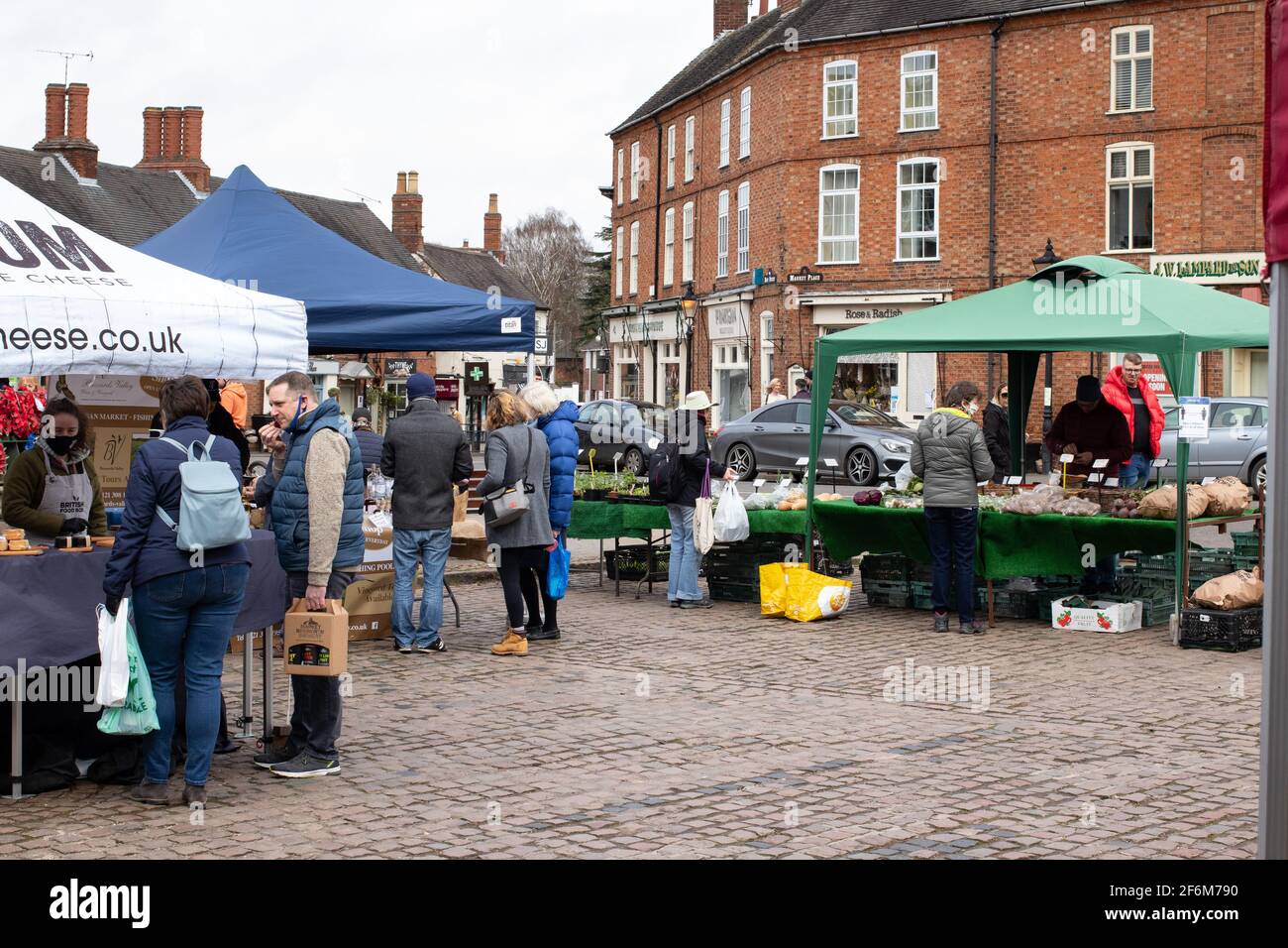 Farmers Domenica Market che si svolge nella Piazza del mercato, Market Bosworth, Leicestershire. Un tipico piccolo paese inglese Domenica mercato di vendita di cibi, bevande, piante e verdure. La foto è stata scattata durante il blocco di Covid poco prima che le restrizioni cominciarono ad essere attenuate in Inghilterra. Foto Stock