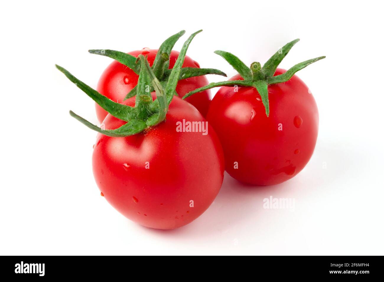Tre pomodori ciliegini rossi maturi con steli verdi isolati bianco Foto Stock