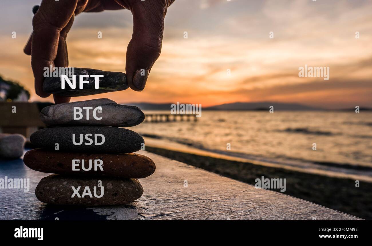 NFT concetto di token non fungibile con pietre. Oro, Dollaro, Euro, Bitcoin e NFT. Foto Stock