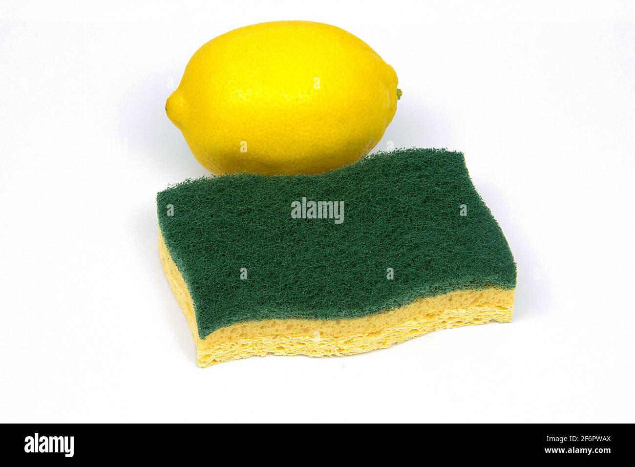 spugna e limone giallo intero su sfondo bianco Foto Stock