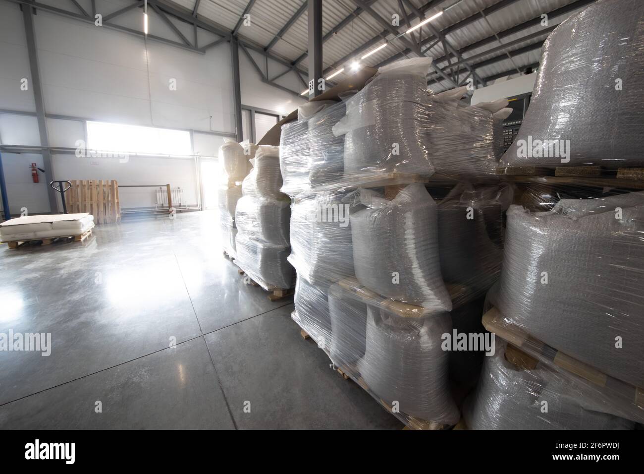 Magazzino spazioso in fabbrica con scaffali e ripiani speciali e prodotti collocati su di essi. Foto Stock
