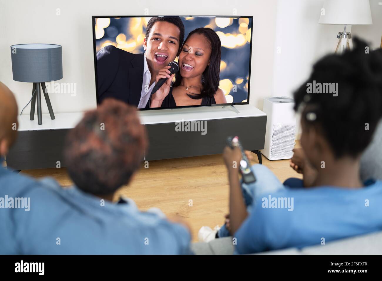 Famiglia africana che guarda film in TV in televisione Foto Stock