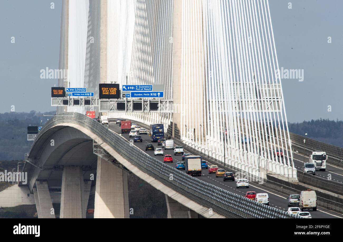 Informazioni sul traffico leggere 'Stay Local, Stay Safe, Save Lives' sopra la M90 sul Queensferry Crossing vicino Edimburgo, a seguito dell'allentamento delle restrizioni di blocco della Scozia per consentire una maggiore libertà all'aperto. Data immagine: Venerdì 2 aprile 2021. Foto Stock