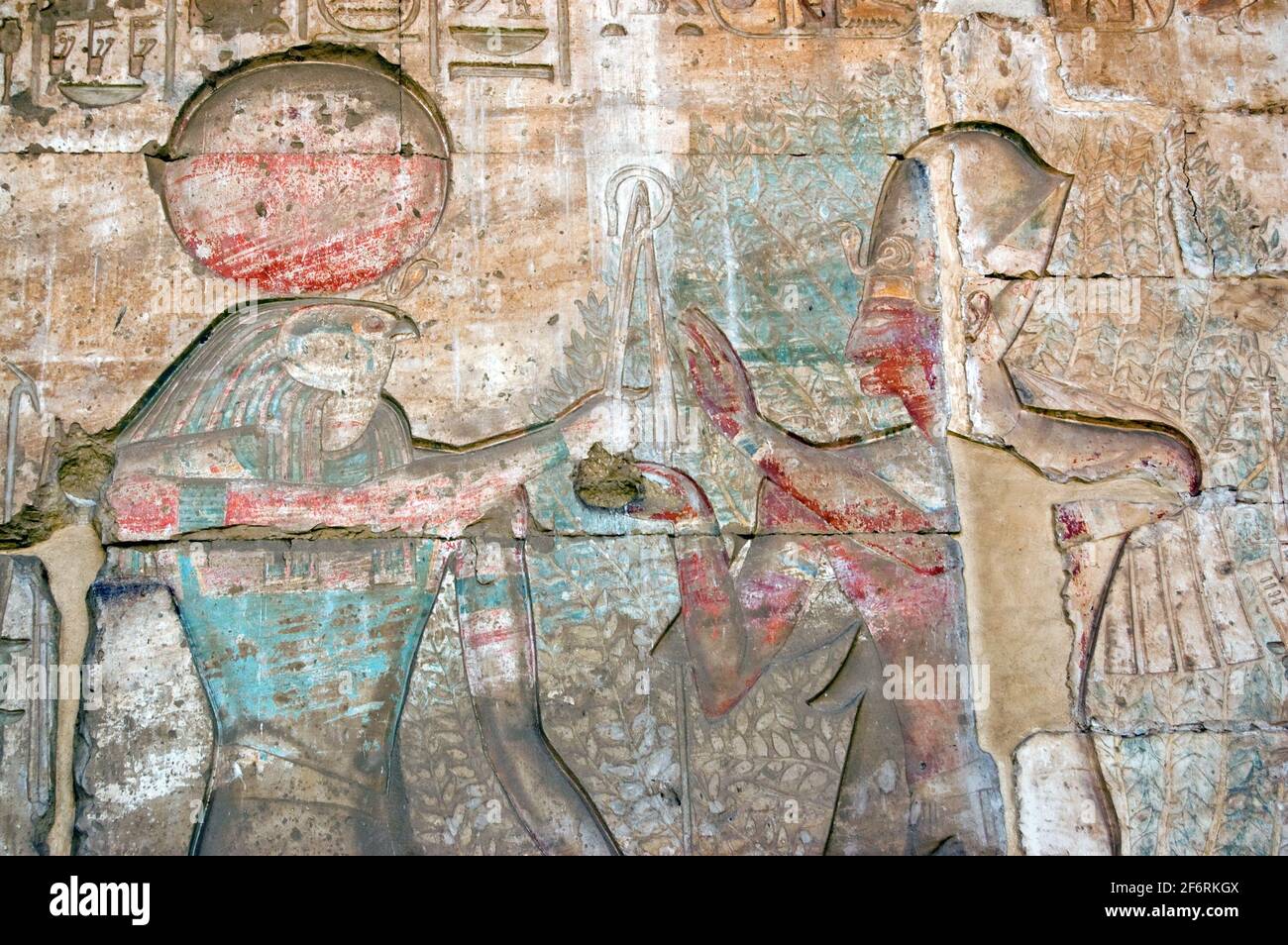 Un'antica scultura geroglifica egiziana che mostra il falco guidato da dio Horus con il faroah Ramses II prima dell'albero sacro della vita. Sculture giganti Foto Stock