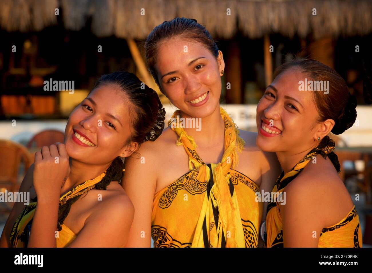 Ritratto di gruppo di tre, giovani. Attraenti filippine che lavorano in un ristorante sulla spiaggia a Logon, Malapascua Island, Cebu, Filippine. Foto Stock