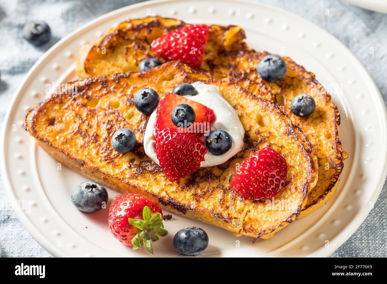 Toast alla francese Eggnog fatto in casa con panna montata e berries Foto Stock