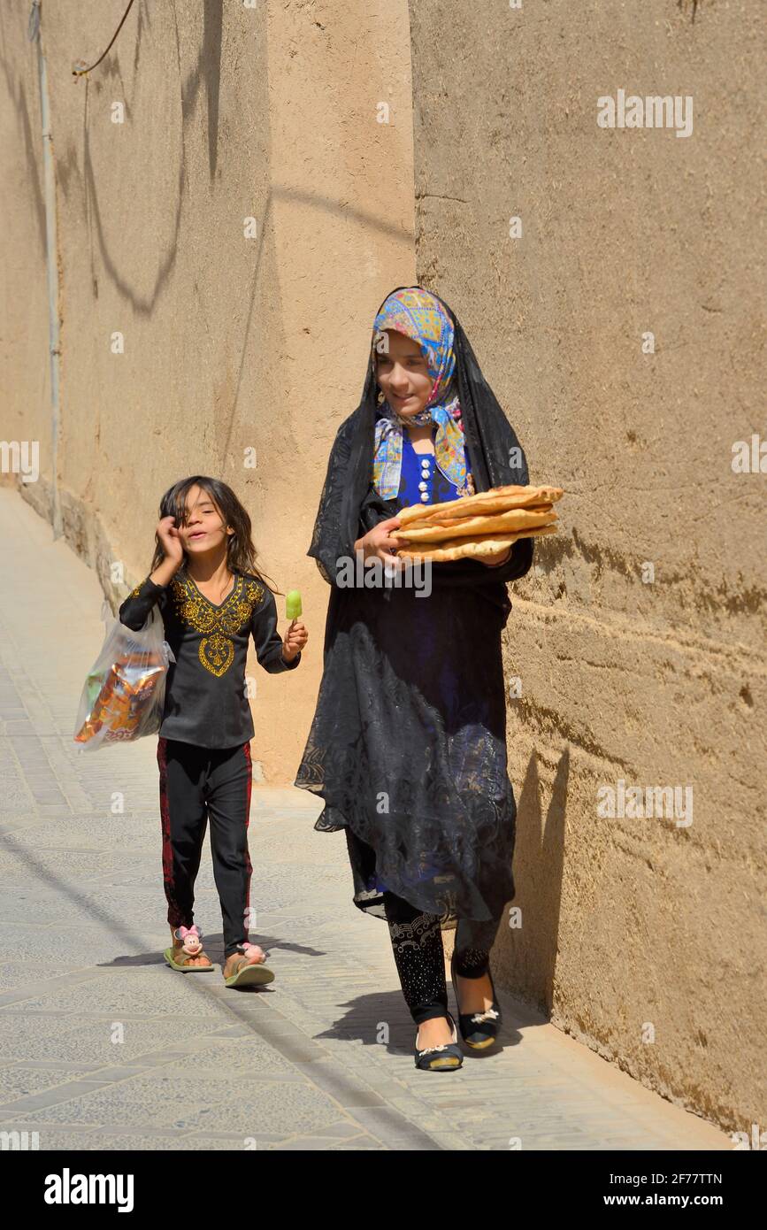 Iran, Yazd, Patrimonio Mondiale dell'UNESCO, la città vecchia, portando il pane a casa Foto Stock