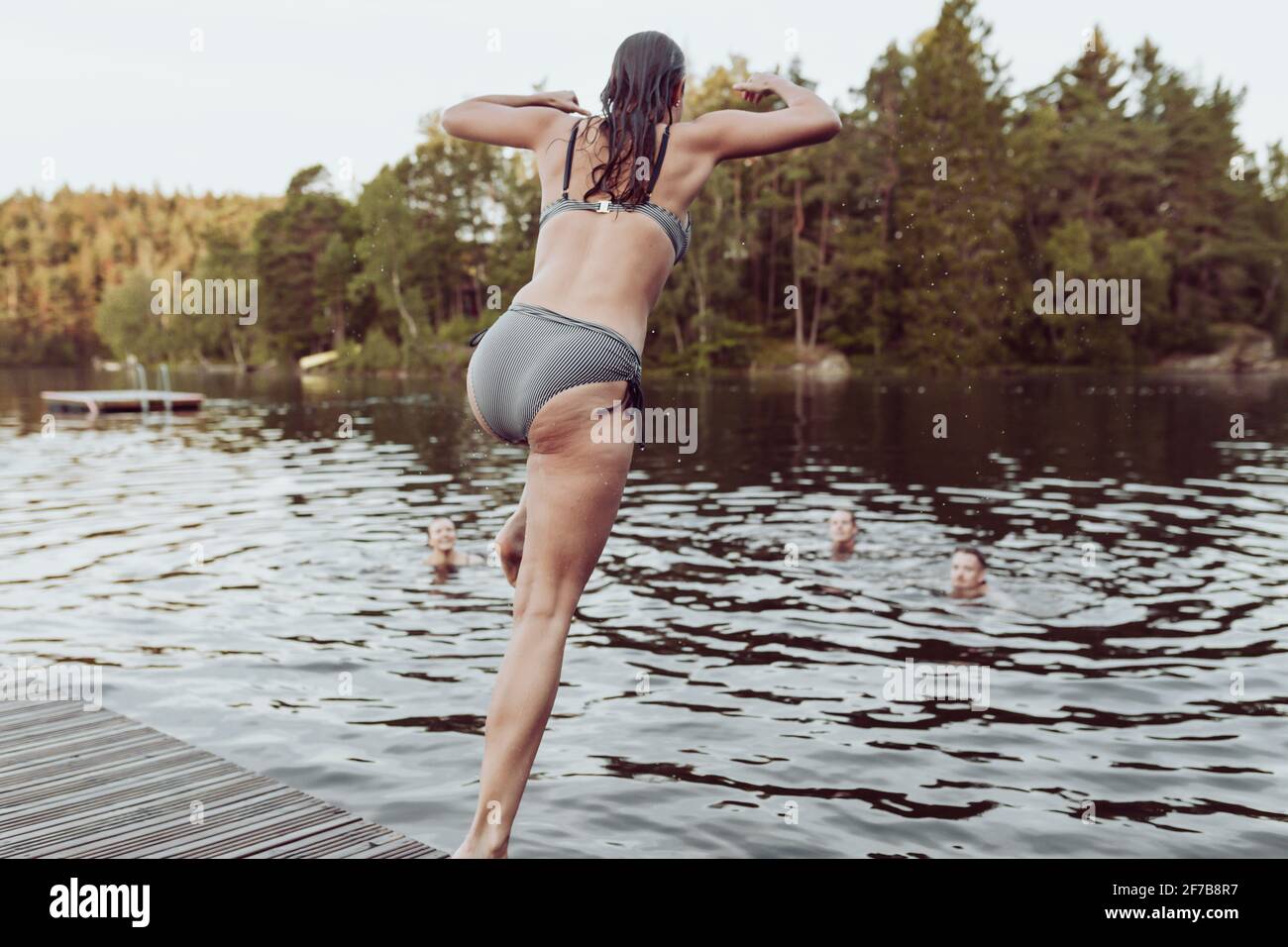 Donna che si tuffa nel lago Foto Stock