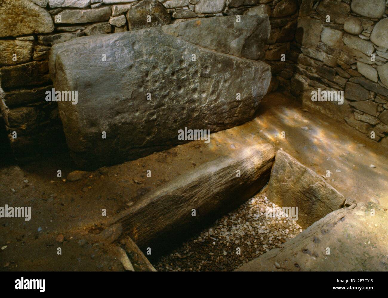 Il cist sepolcrale & il capstone decorati con due assi, & i cupmarks & assi all'interno di Nether Largie North Bronze Age round cairn, Kilmartin Glen, Scozia, Regno Unito. Foto Stock