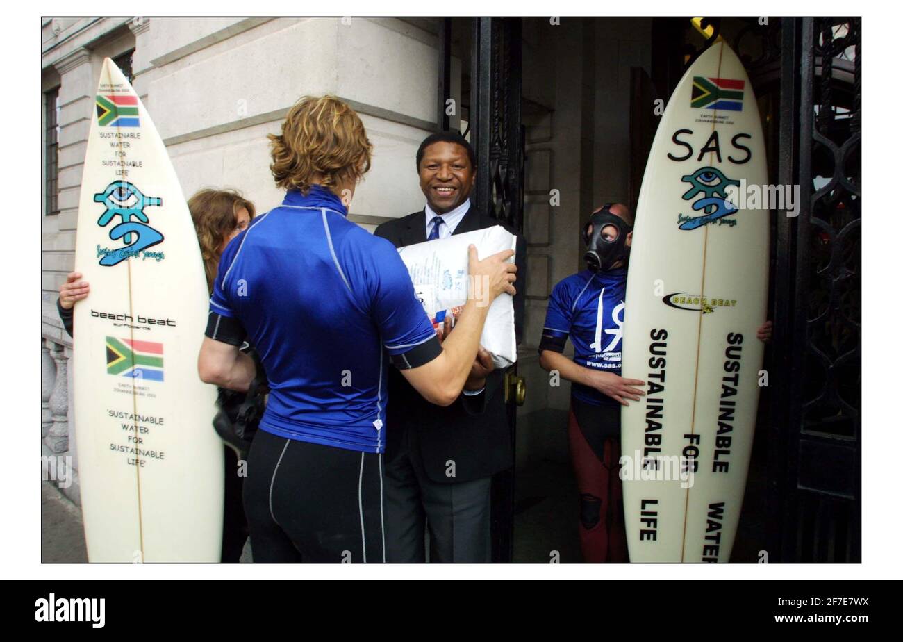 Una delegazione Surfers Against Sewage di surfers wetsuited con maschere antigas E messaggi di acqua sostenibile per la vita sostenibile sul loro Tavole da surf in Trafalgar Square prima di consegnare un sacco grande di I fanghi di depurazione riciclati all'Alto Commissariato sudafricano Del vertice della Terra a Johannesburg la prossima settimana.pic David Sandison 22/8/2002 Foto Stock