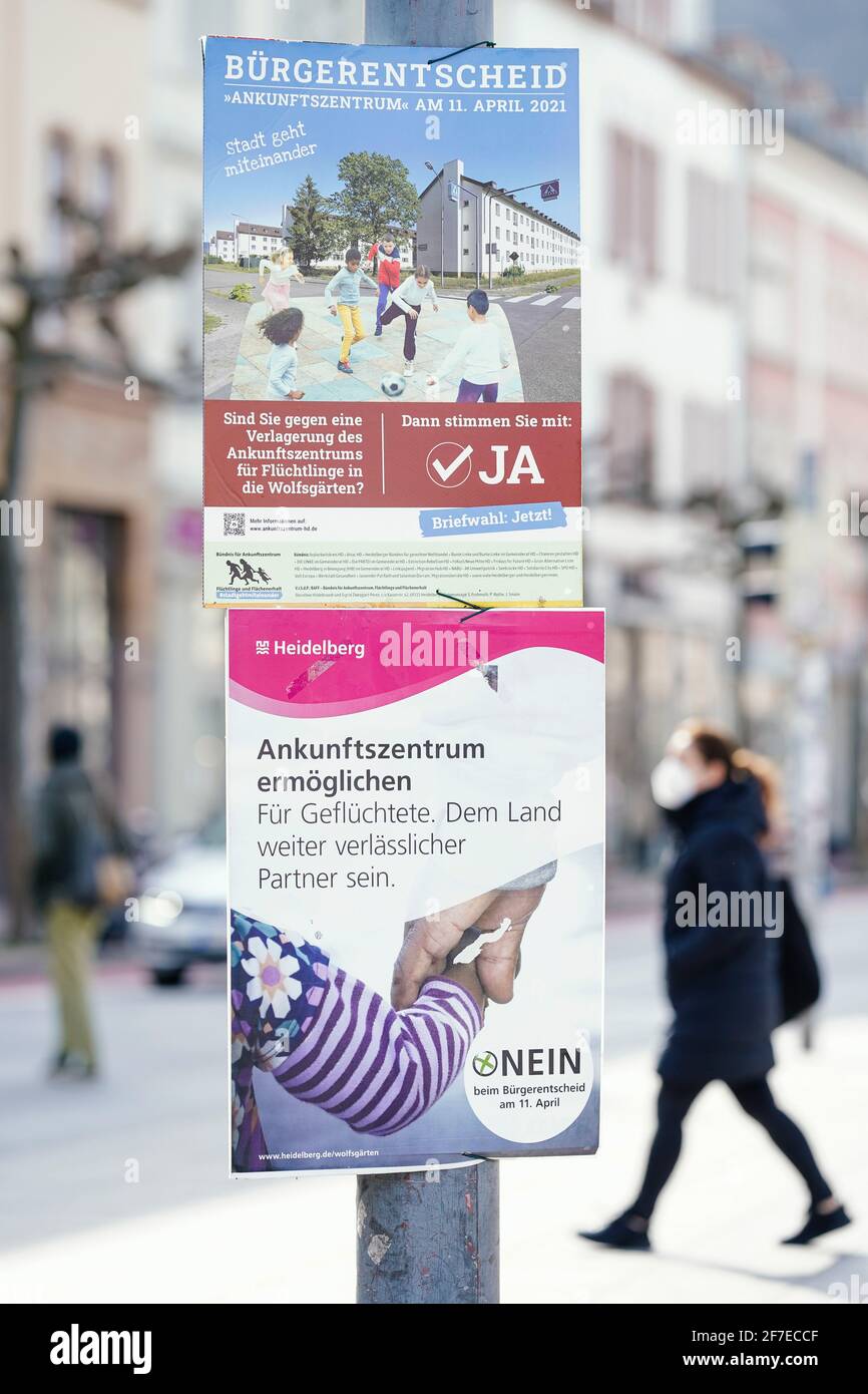 25 marzo 2021, Baden-Wuerttemberg, Heidelberg: Manifesti elettorali che richiamano l'attenzione sul referendum del 11 aprile sono appesi a Bismarckplatz, nel centro della città. La popolazione di Heidelberg potrà quindi votare sulla futura sede del centro di arrivo per i rifugiati. L''Alliance for Arrival Center, Refugees and Land Preservation' (BAFF) vuole impedire il trasferimento del centro nell'ex insediamento statunitense Patrick-Henry-Village (PHV) in un'area precedentemente utilizzata dal punto di vista agricolo chiamata 'Wolfsgärten'. (A dpa: 'Centro di arrivo dei rifugiati - residenti di Heidelberg votare sulla posizione') Foto: Uwe Ansp Foto Stock