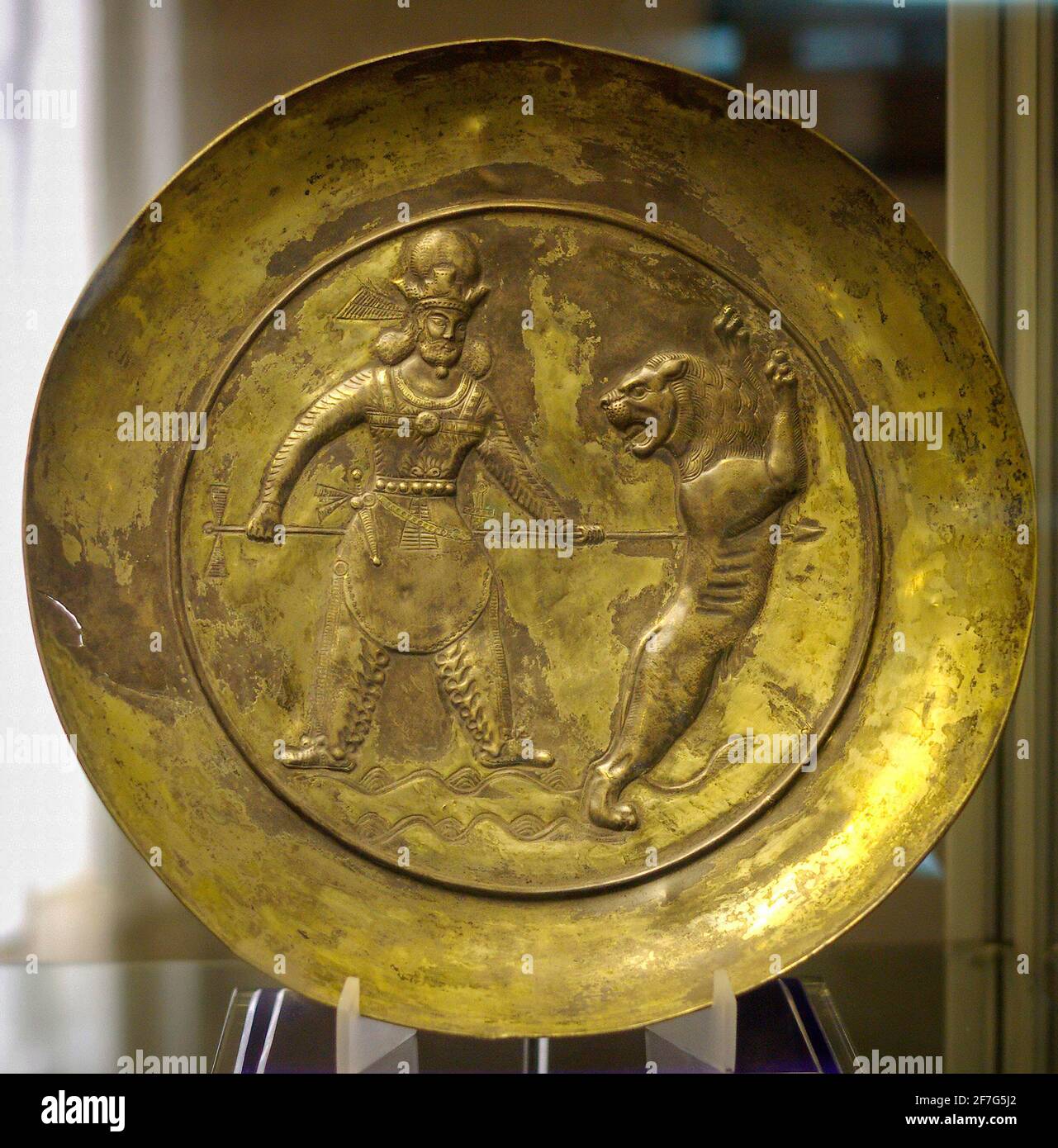 Piatto d'argento dorato sasaniano raffigurante il Re che uccide un leone con una spada, Museo Tabriz, Iran. Foto Stock
