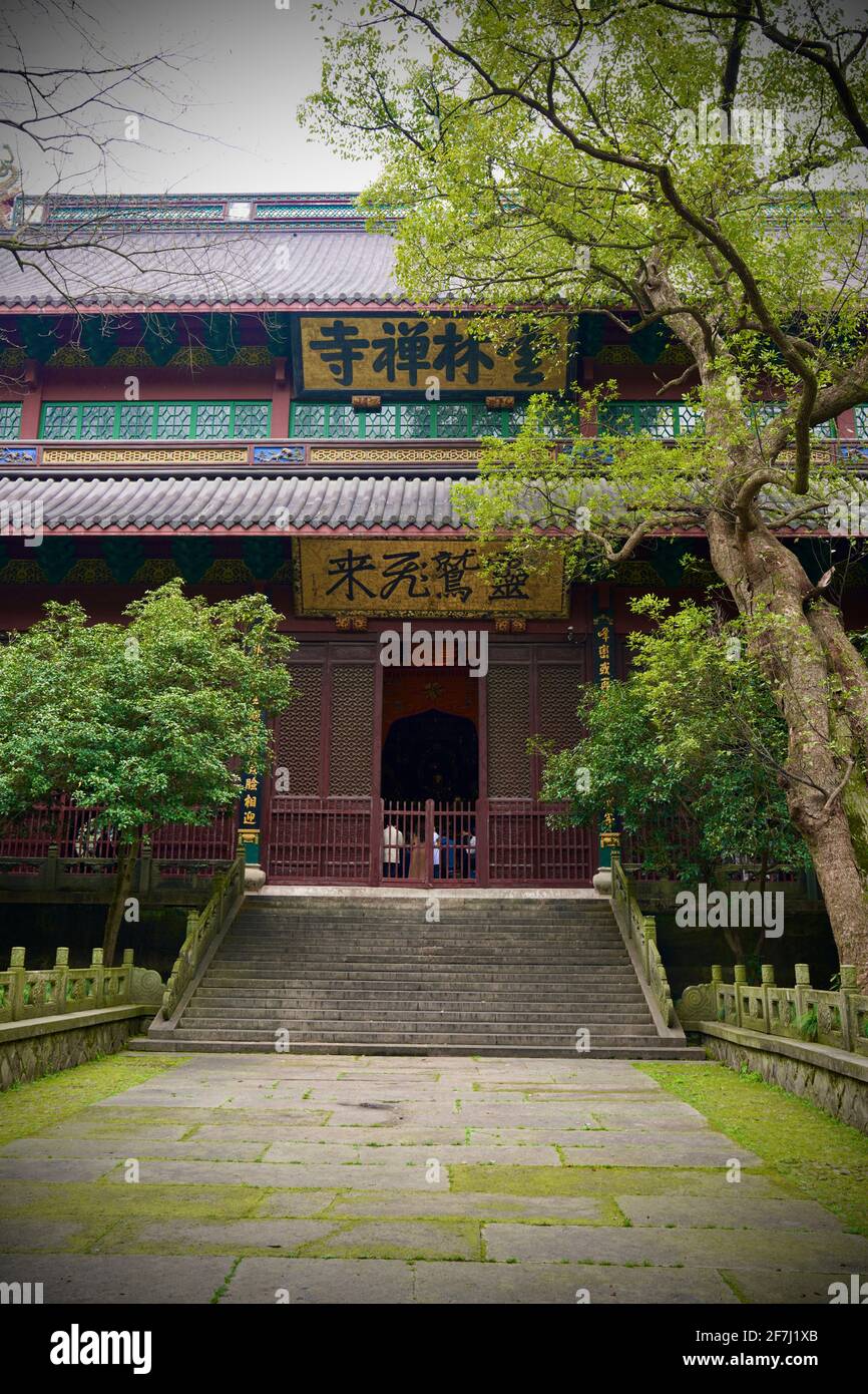 Uno dei Templi del Tempio Lingyin si trova a Hangzhou, Zhejiang, Cina, con la porta di fronte in legno, molti gradini, edificio di vecchio stile e alberi verdi. Foto Stock