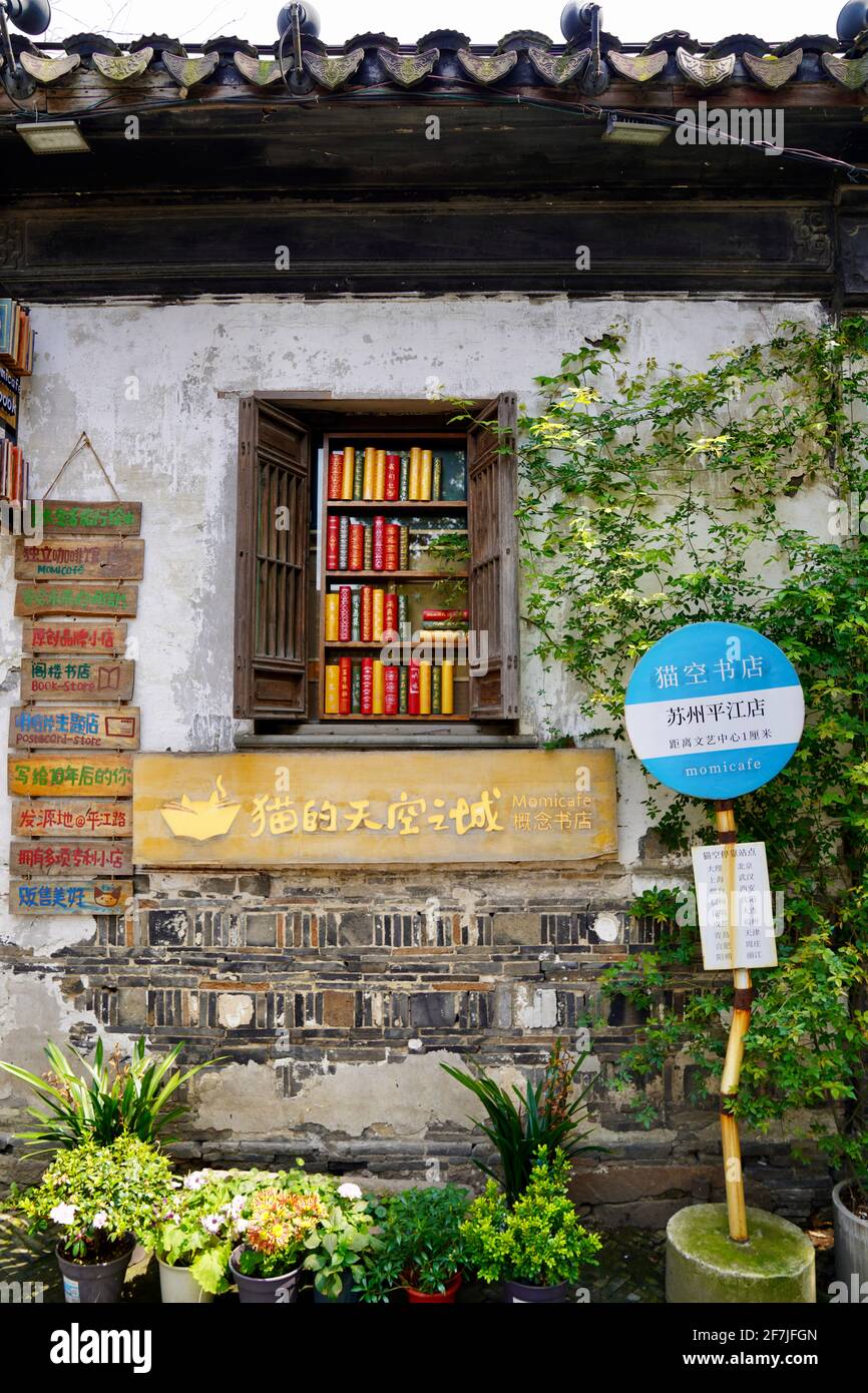 Un negozio di libri chiamato città cielo del gatto con la finestra scaffale libro e stazione di fronte ad essa. Foto Stock