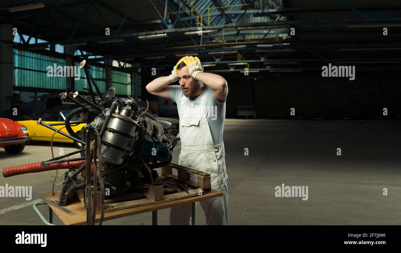 Il motore è difettoso dal meccanico addetto alla manutenzione dell'auto classica Foto Stock