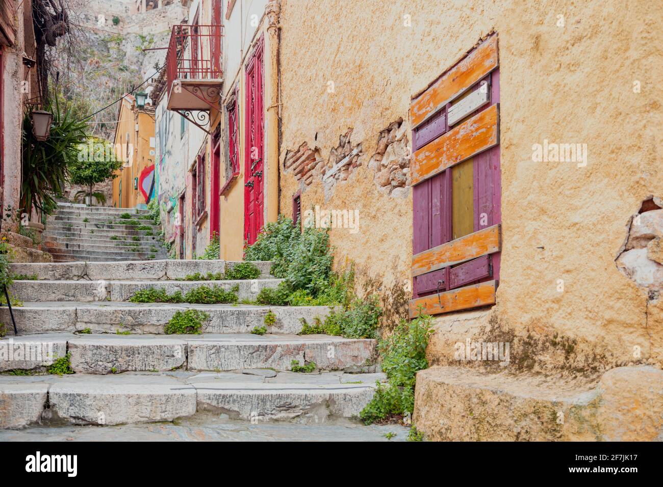 Città vecchia Plaka, Atene destinazione Grecia. Vecchi e vuoti scalini in pietra tradizionali dal basso verso l'alto, strette strade pedonali, bucato multicolore Foto Stock