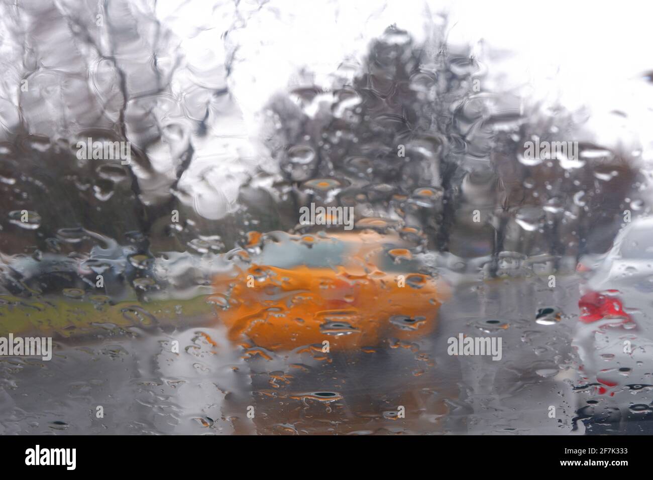 Gocce d'acqua alla finestra in un giorno piovoso, Taxi su Wet Road Foto Stock