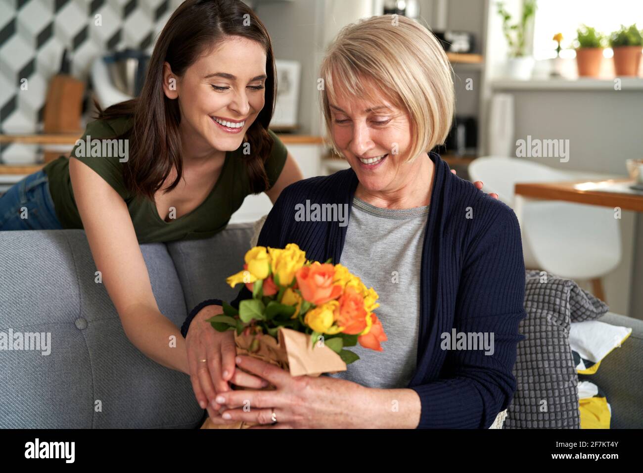 Figlia che dà fiori a sua madre Foto Stock