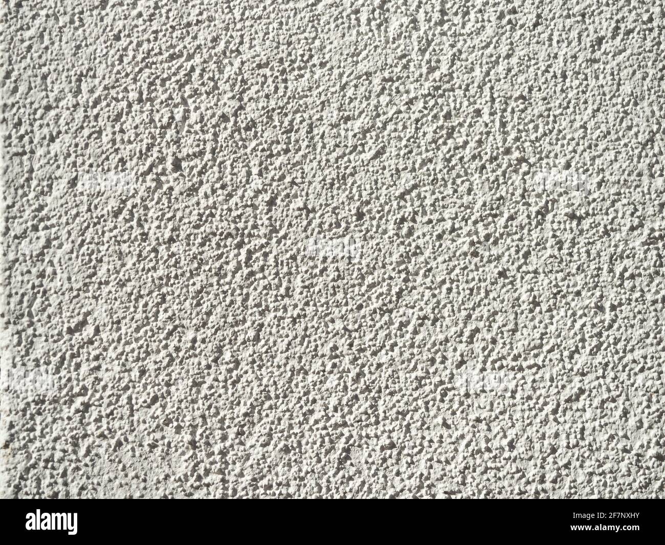 pareti di colore bianco ruvido con luce solare intensa che mette in evidenza la texture Foto Stock